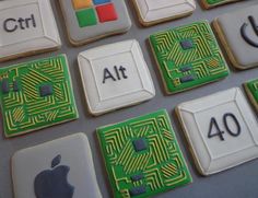 some cookies that are shaped like computers and circuit boards with the words at on them