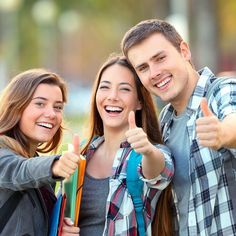 two smiling young people giving thumbs up