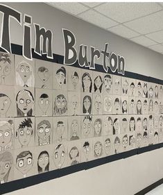 a wall with cartoon faces on it and the words tim burton written in large letters