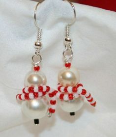 the earrings are decorated with red and white beads