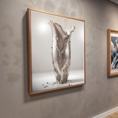 three framed photographs hang on the wall next to each other