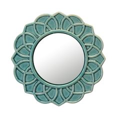 a round mirror sitting on top of a white wall