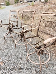 four chairs sitting on top of a gravel field