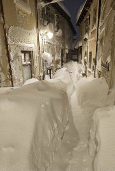 a street is covered in snow at night