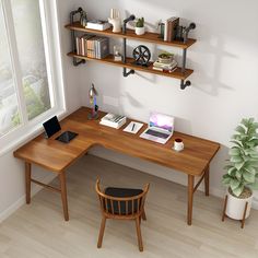 a computer desk with a laptop on it next to a potted plant and bookshelf