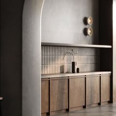 a kitchen with wooden cabinets and counter tops in an arch - shaped space between two walls