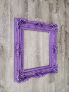 an empty purple frame on a wooden wall