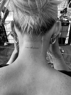 a woman with a small tattoo on her neck