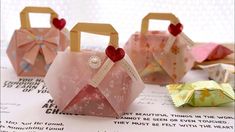 three small pink bags with hearts on them sitting on top of a piece of paper