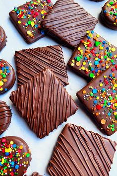 chocolate covered cookies with sprinkles on a table