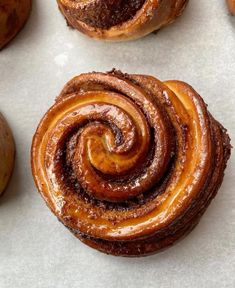 some cinnamon rolls are sitting on a table