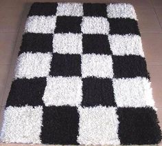 a black and white checkered rug on the floor