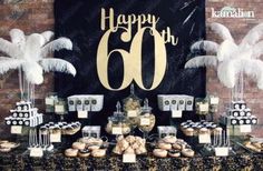 a table topped with cakes and cupcakes next to a sign that says happy 60th