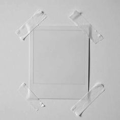 an empty white square frame surrounded by torn pieces of paper