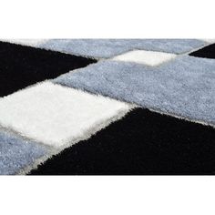 a black, white and blue rug with squares on it