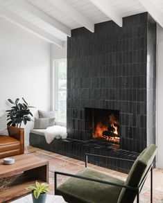 a living room filled with furniture and a fire place in the middle of a fireplace