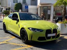 a bright yellow sports car parked on the street