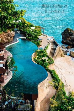 an outdoor swimming pool next to the ocean