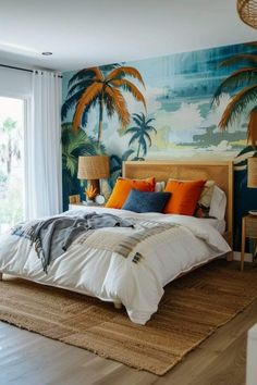 a bedroom with palm trees painted on the wall and large bed in front of it