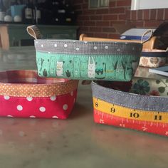 three measuring bowls with cats and polka dots on them