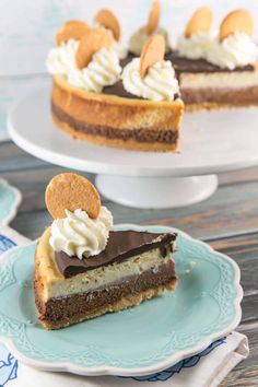 a slice of chocolate cheesecake on a blue and white plate with a bite taken out of it