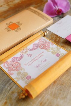 the wedding stationery is laid out on the table next to the envelope and pen