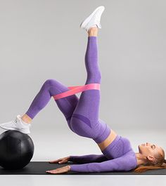 a woman is doing an exercise with a ball