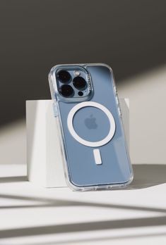 an iphone case sitting on top of a white stand