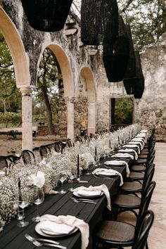 the tables are set with black and white linens for an elegant wedding reception in italy