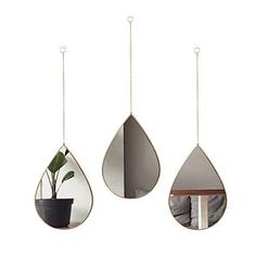 three hanging tear shaped mirrors with plants in them