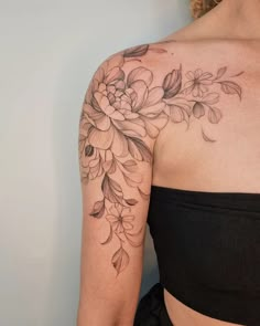 a woman's shoulder with flowers on it