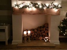 a fire place with candles and christmas decorations