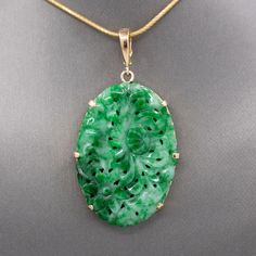 Lush Green Jadeite Jade Chrysanthemum Carved Pendant Enhancer in 14k Yellow Gold This gorgeous green jadeite jade pendant/enhancer is beautifully carved and crafted.  The jade features a scalloped edge all of the way around and features the petals and flower of a chrysanthemum.  The jade is brightly colored with apple and spinach green and paler celadon areas.  The jade measures 1 1/2" in length excluding the bail.  Including the bail the piece measures 2 1/8" in length.  The back of the bail snaps open so that it can be used as an enhancer over pearls or another necklace.  The piece measures 1 1/8" across.  The frame and bail are crafted in 14k and the piece weighs 11.06g. The chain is not included in this listing. Jade Pendant, Chrysanthemum, Lush Green, Fine Jewellery Necklace, Jade, Jewelry Necklace Pendant, Fine Jewelry, Yellow Gold, Jewelry Necklaces