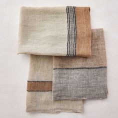 three pieces of cloth folded on top of each other, with different colors and patterns