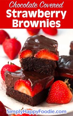 chocolate covered strawberry brownies are stacked on top of each other with strawberries in the background