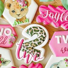 decorated cookies with the words live, love, and leopard print on them sitting on a table