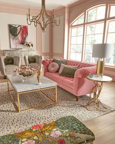 a living room filled with pink couches and chairs