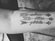 a woman's arm with an arrow and some words tattooed on the side of it