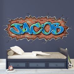 a bedroom with a brick wall that has graffiti on it and the word tacob written in blue