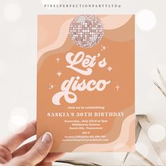 a person holding up a party card with the words let's disco on it