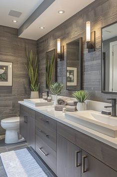 a bathroom with two sinks and three mirrors