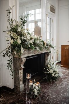 a fireplace decorated with flowers and candles