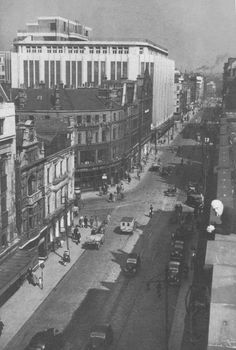 an old black and white photo of a city street