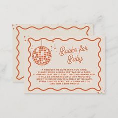 an orange and white baby shower card with a disco ball on it's back