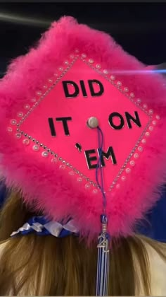 a woman wearing a pink graduation cap with the words did it on em written on it