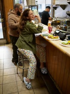 a woman sitting at a counter with food in front of her