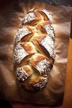 a loaf of bread sitting on top of a piece of wax paper