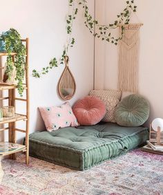 a living room filled with lots of furniture and plants on top of the wall next to a rug