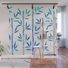 a wall mural with bamboo trees painted on it's side in blue and white