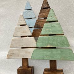 three wooden christmas trees sitting next to each other